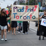 Mad Pride Banner at front of parade